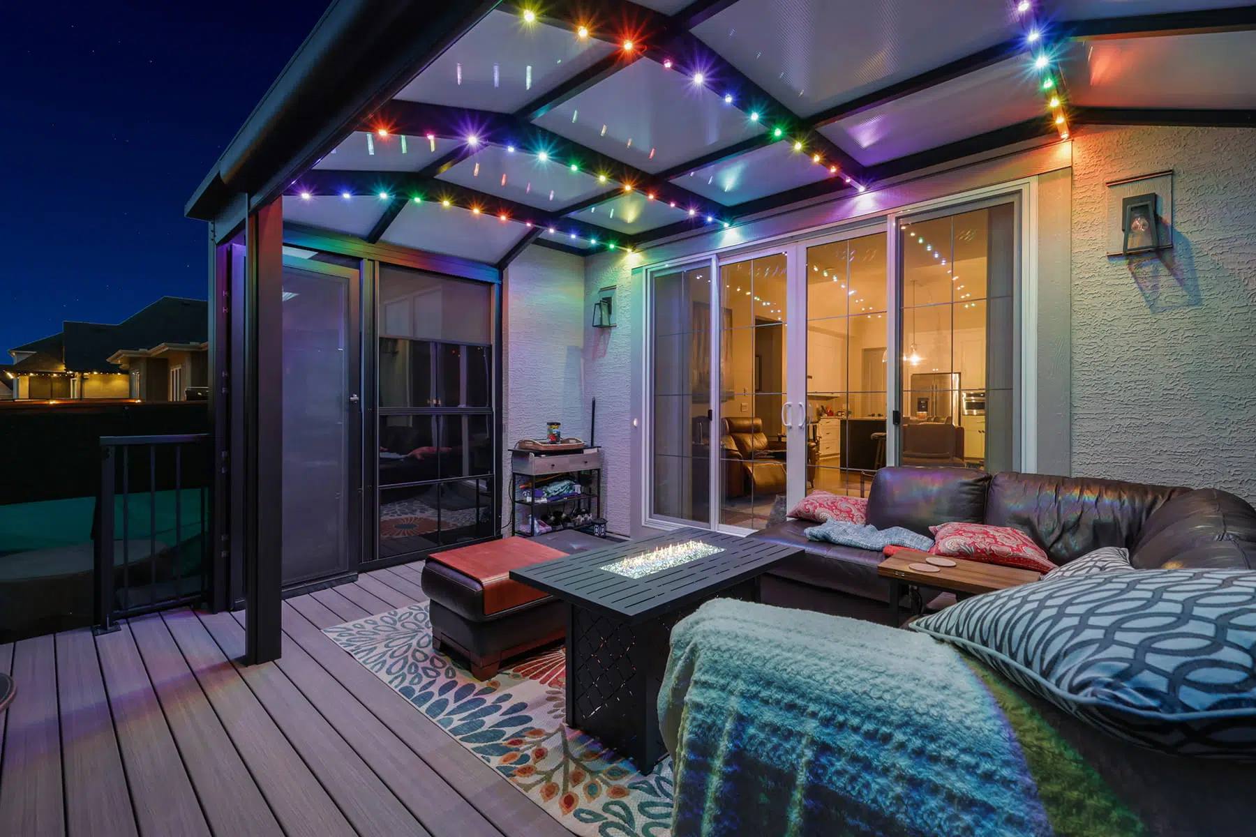 Covered backyard patio with multicolour Gemstone lights along the pergola