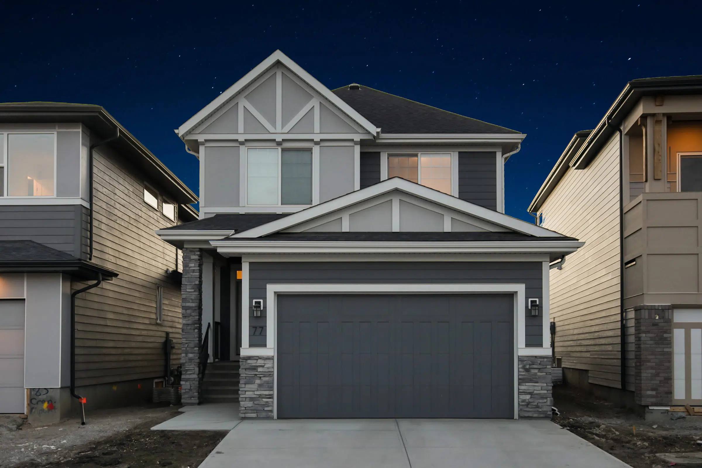 Two-storey home at dusk with no outdoor lights on