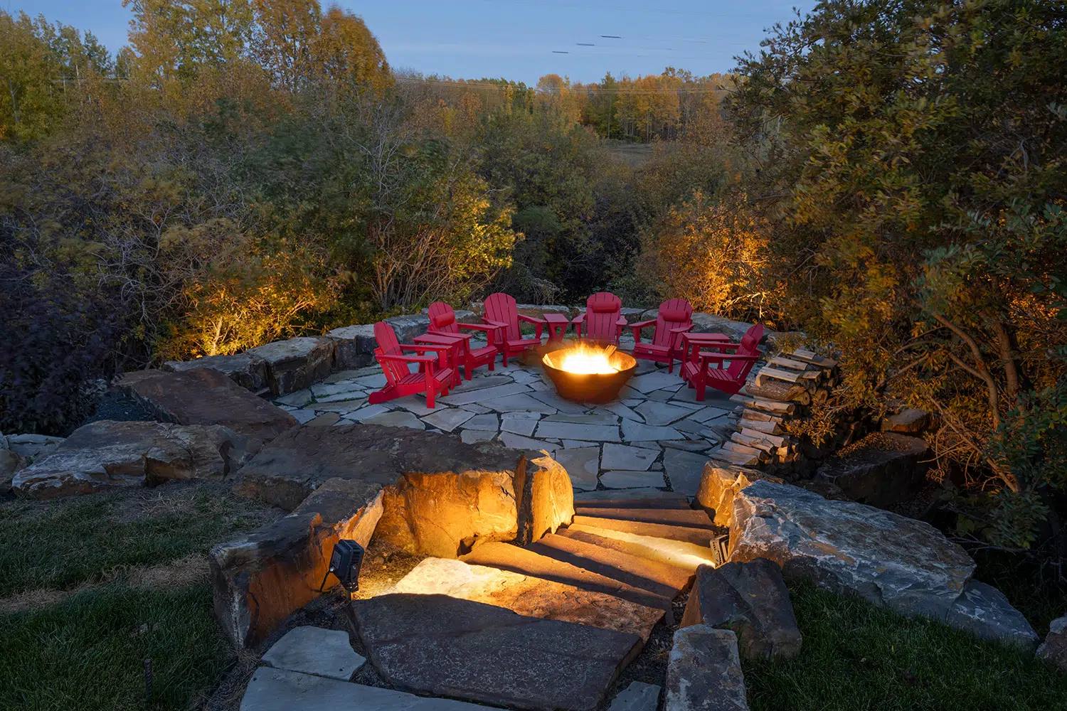 Fire pit area and stone steps lit with warm Gemstone landscape lights