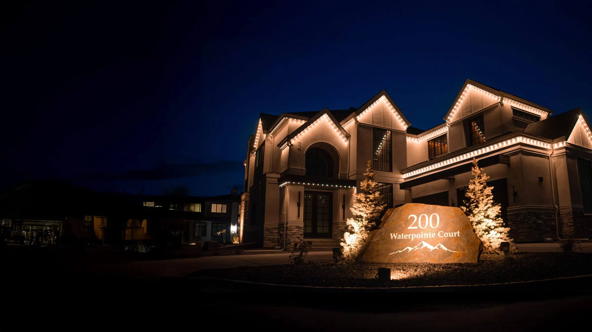 Home and address sign lit by warm white Gemstone landscape lights