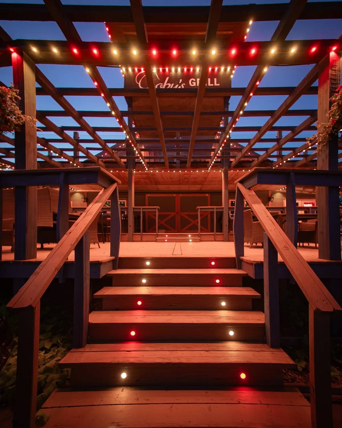Deck and pergola lit red with Gemstone lights