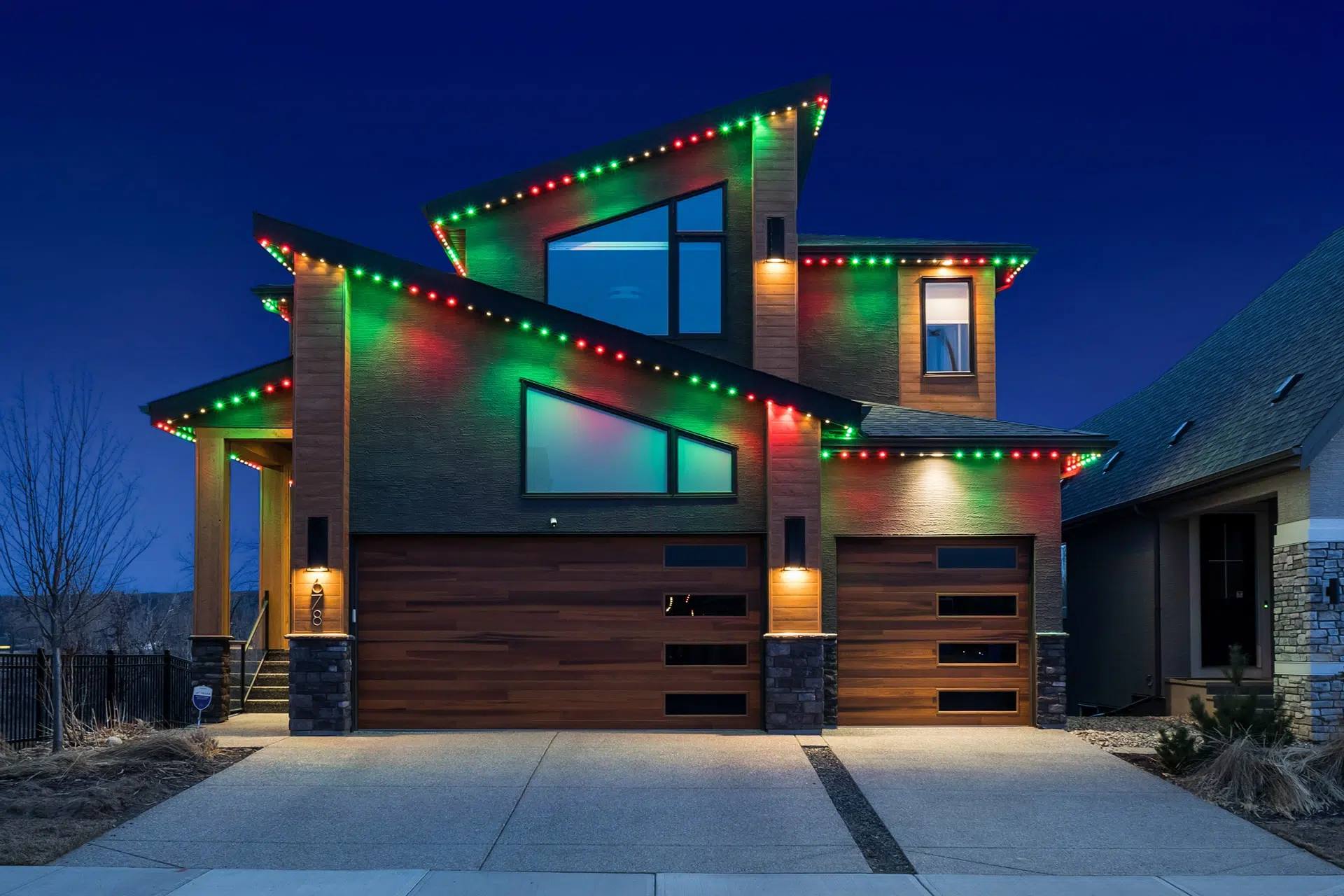 Modern home with red and green Gemstone lights on every roofline