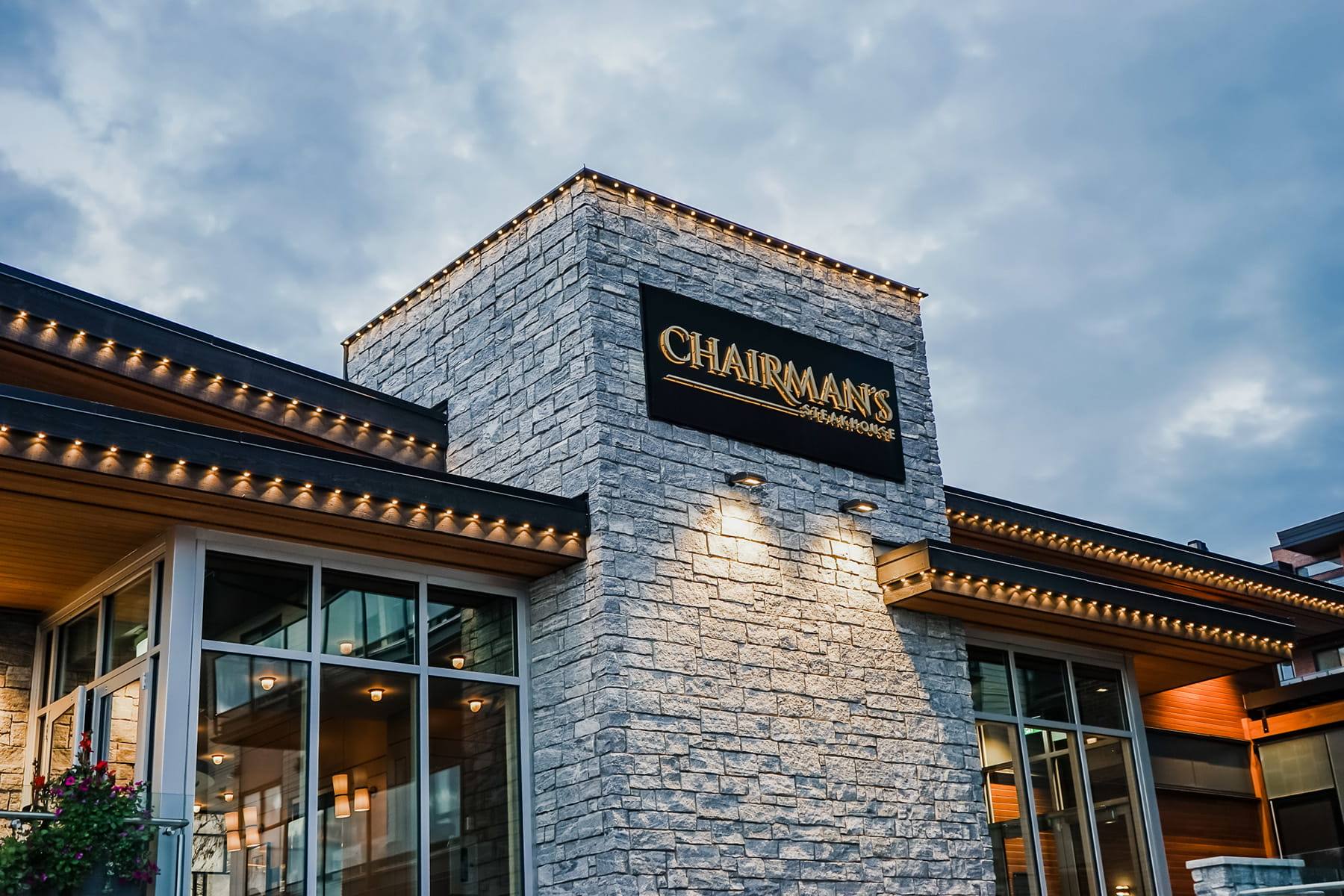 Restaurant with a stone front and warm white Gemstone lights at dusk
