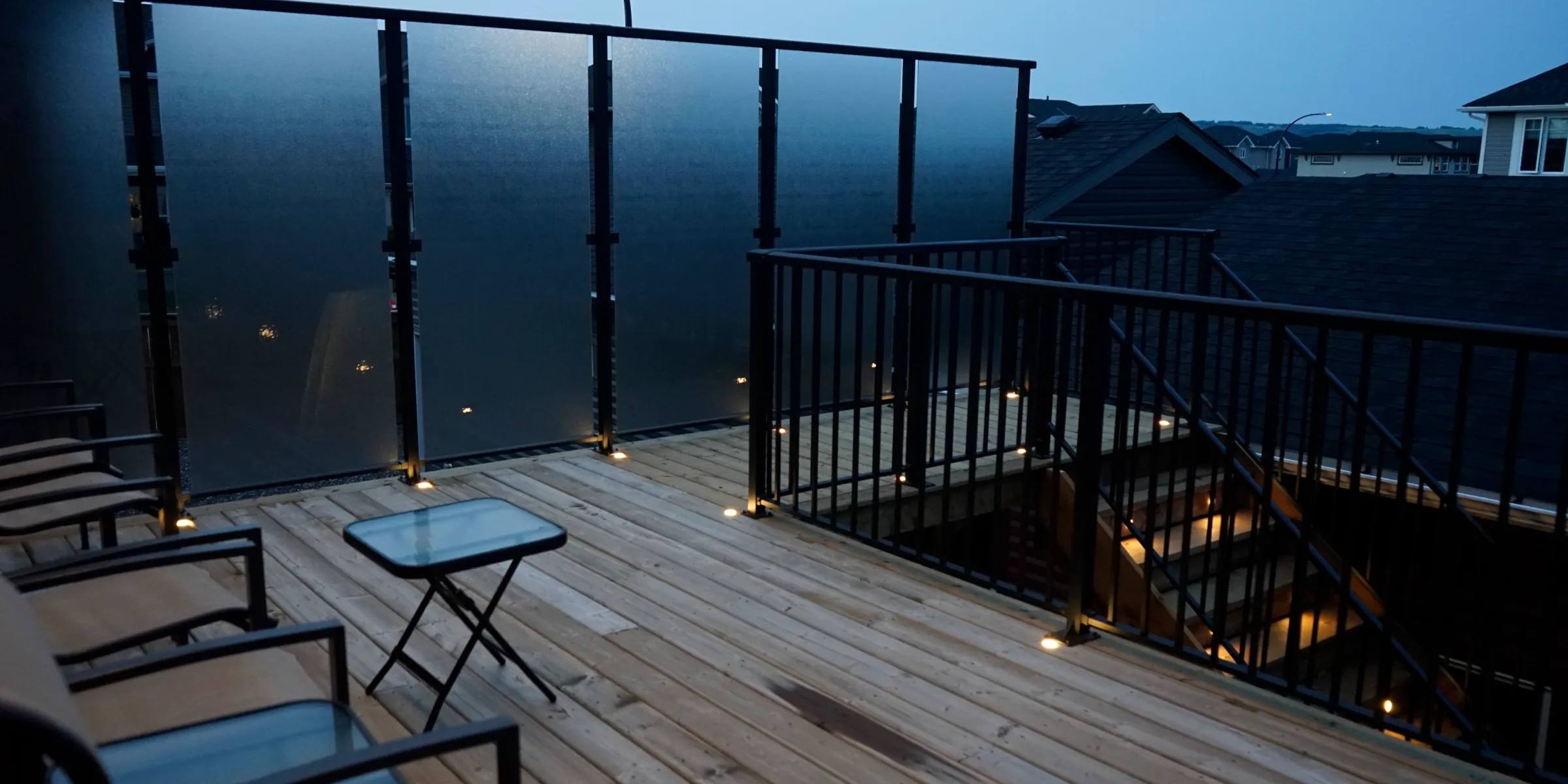 Rooftop deck with small Gemstone lights along the floor at dusk