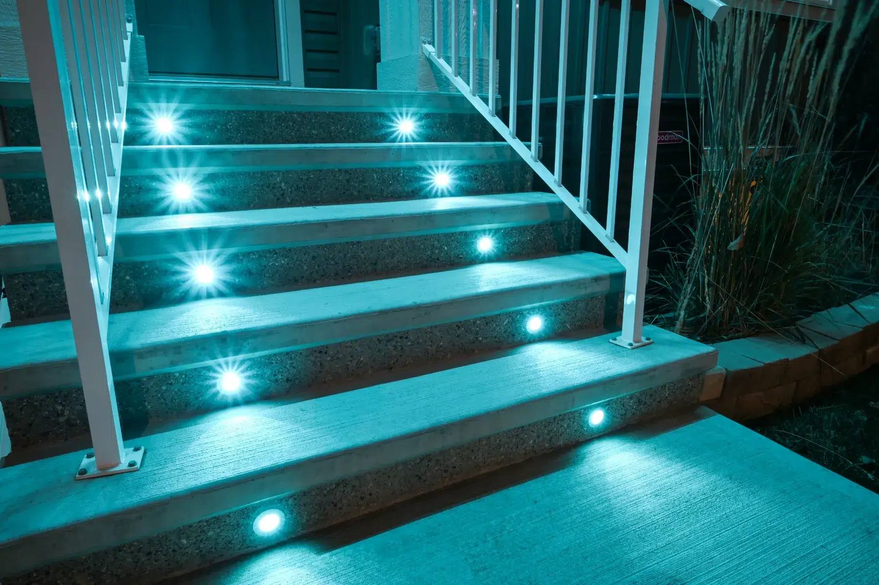 White stairs with teal Gemstone deck lights in the risers
