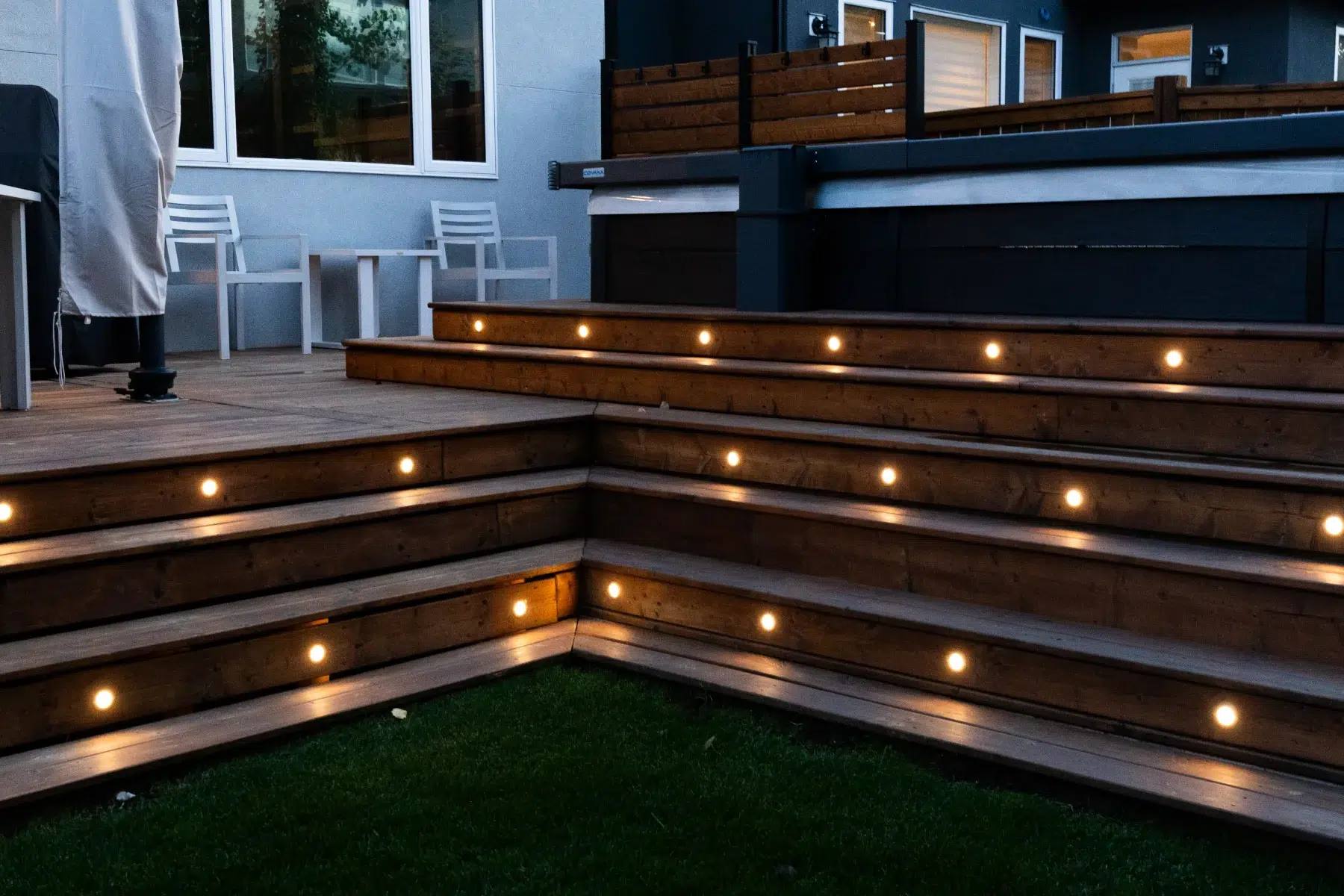Wraparound deck steps lit warm white at dusk